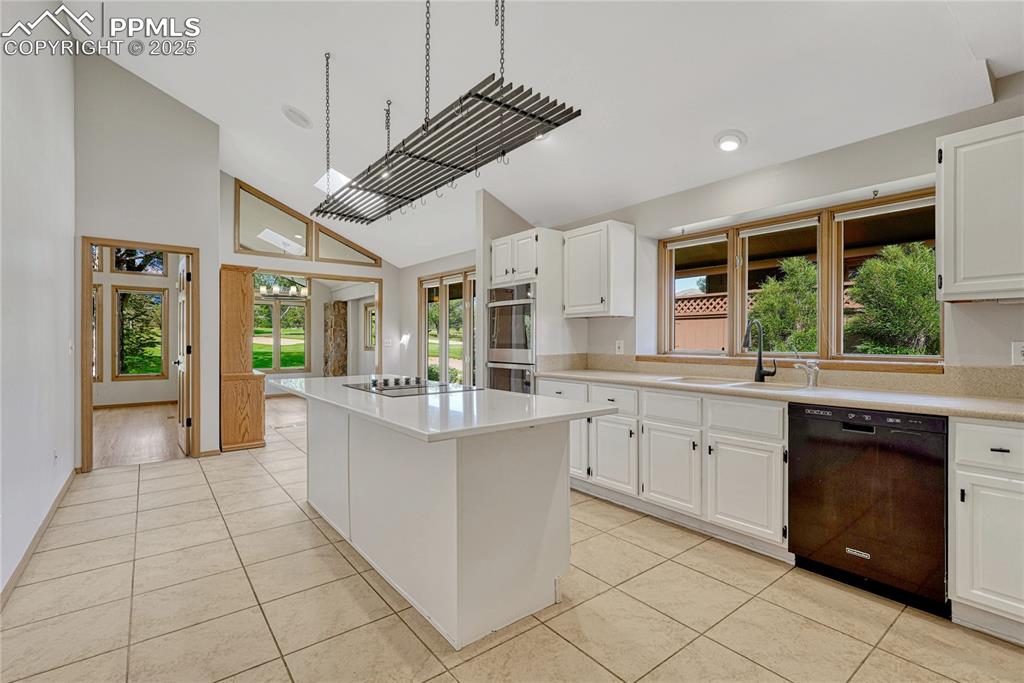 Vaulted Tiled Island Kitchen with Skylight