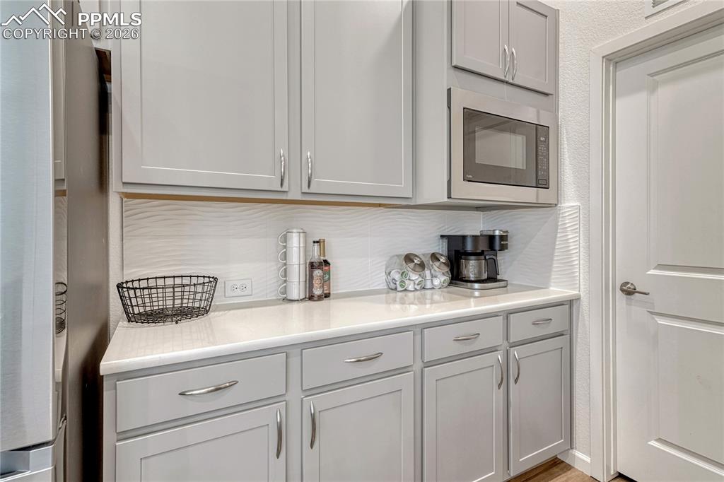 Heading towards the kitchen pantry is another countertop space for a coffee bar or prep area
