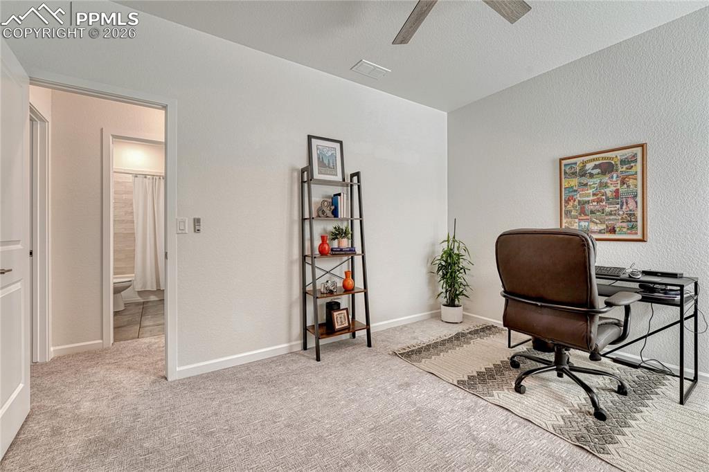 Across the upper level hall bath is a third bedroom with ceiling fan

