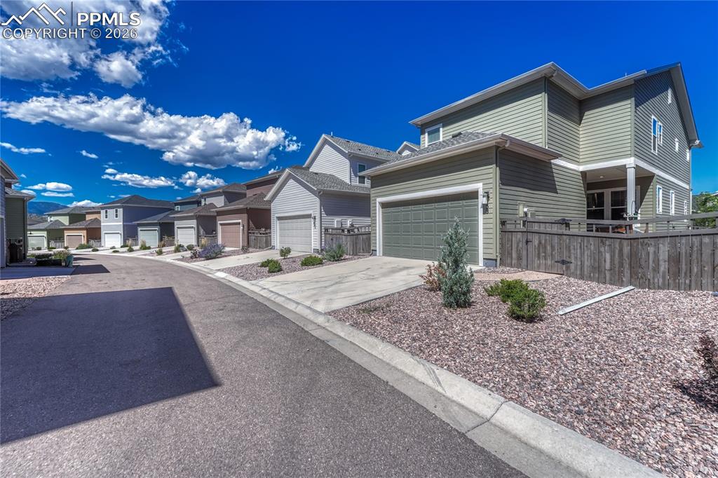 Access to the 2-car attached garage comes from the back “alley” road that offers more parking on the driveways for guests
