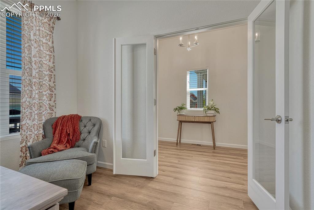 The office is separated by the rest of the home with glass french doors
