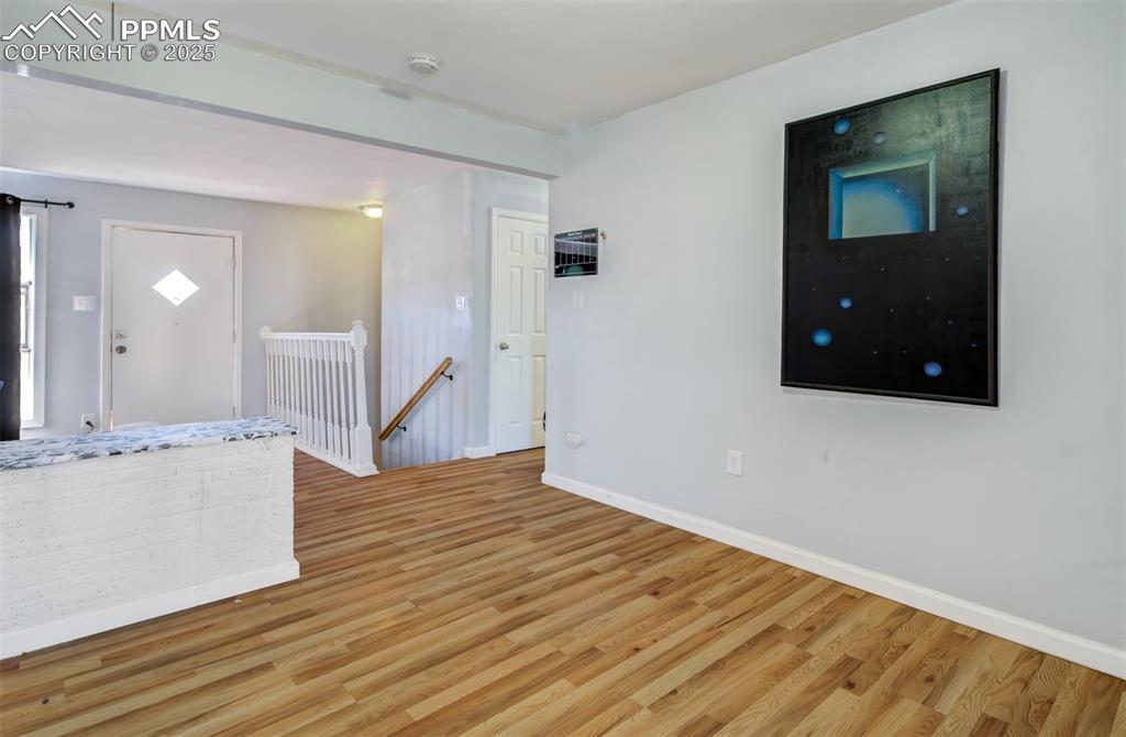 Empty room with baseboards and light wood-style floors