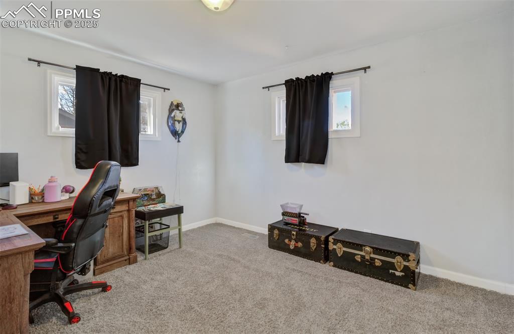 Carpeted office featuring plenty of natural light and baseboards