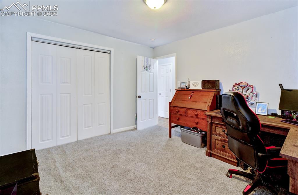 Office area featuring carpet and baseboards