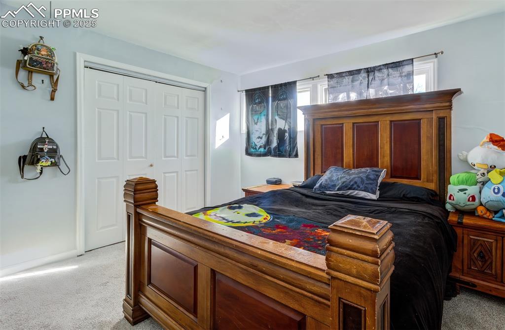 Bedroom with a closet and light colored carpet