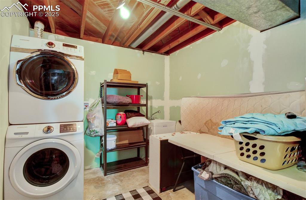 Laundry area with stacked washer / dryer and laundry area