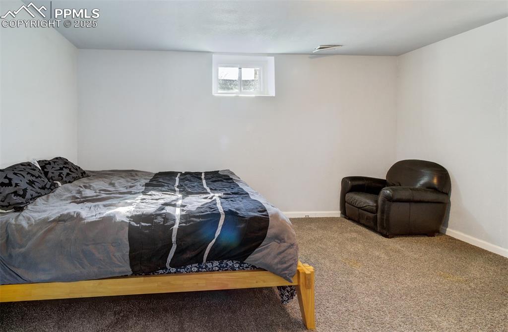 Bedroom featuring baseboards, visible vents, and carpet floors