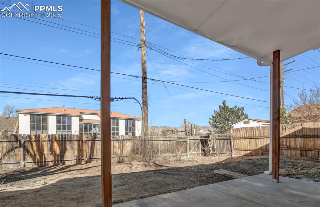 View of yard featuring a fenced backyard and a patio