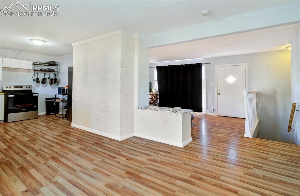 Unfurnished living room with light wood-style flooring