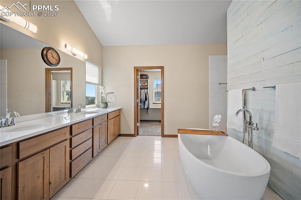 Spa like primary bath with double vanity, soaking tub and huge free standing shower.