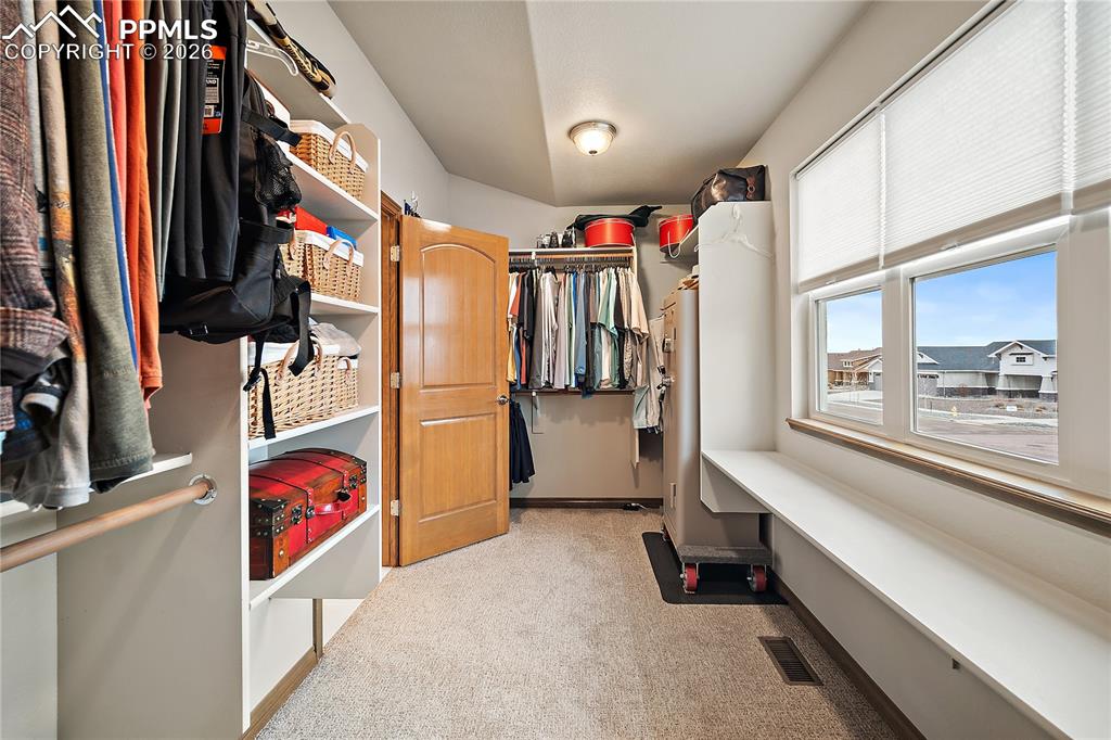 Huge walk in closet with picture window and natural light.