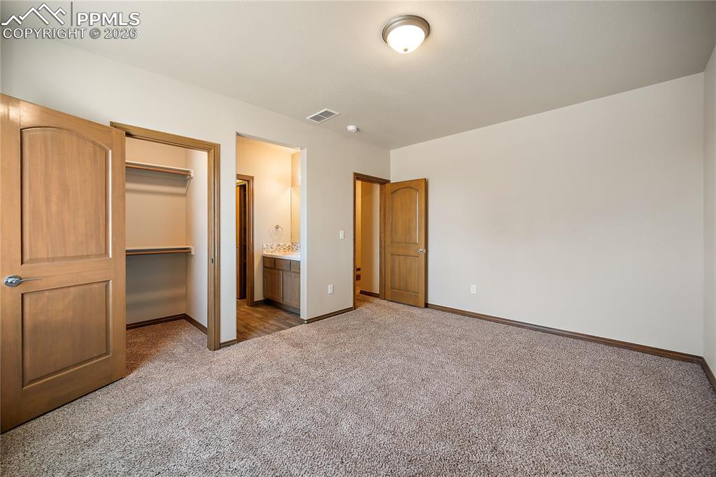 Basement bedroom with carpet, walk in closet and attached Jack-n- Jill bath.