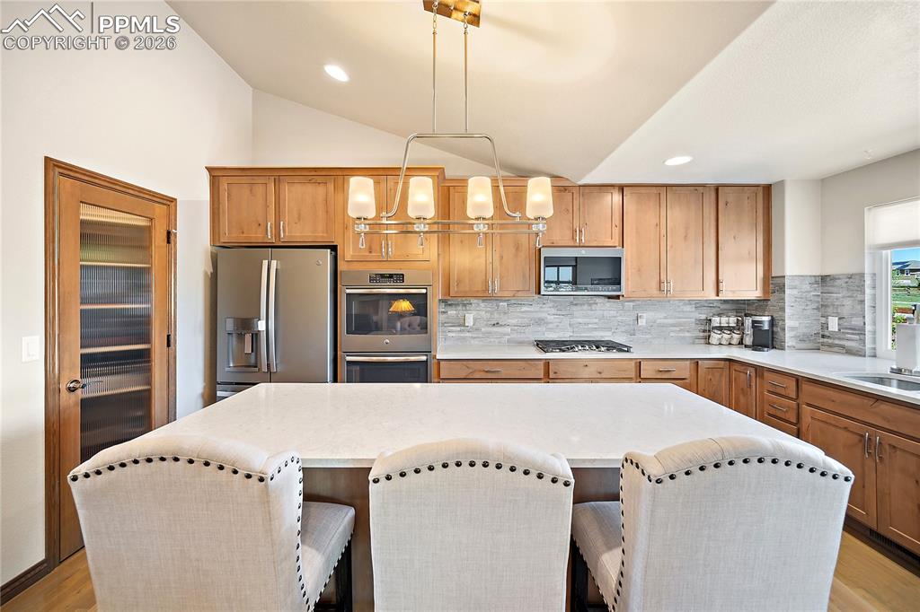 Gorgeous kitchen with stunning quartz countertops, huge island and spacious pantry.