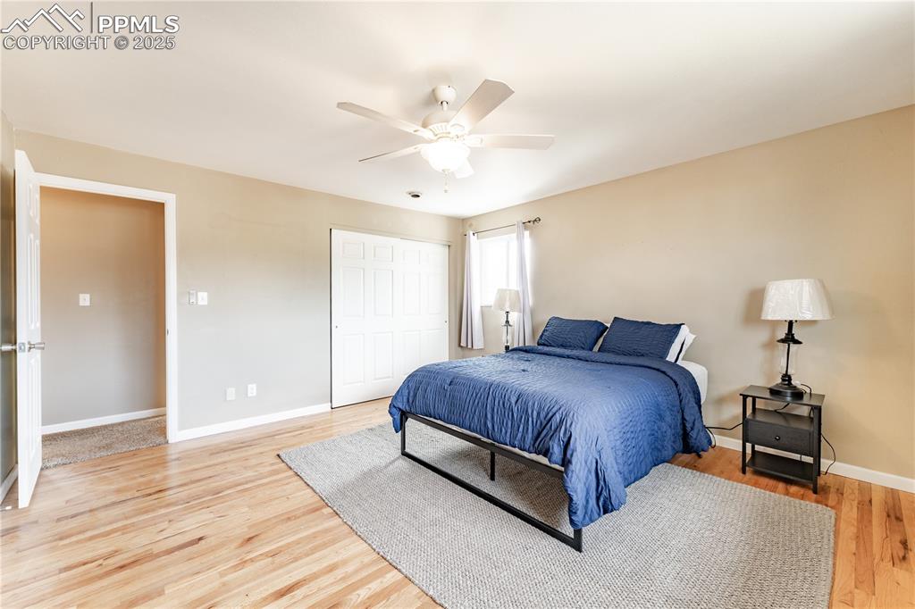 Bedroom featuring a closet, ceiling fan, and light wood-type flooring