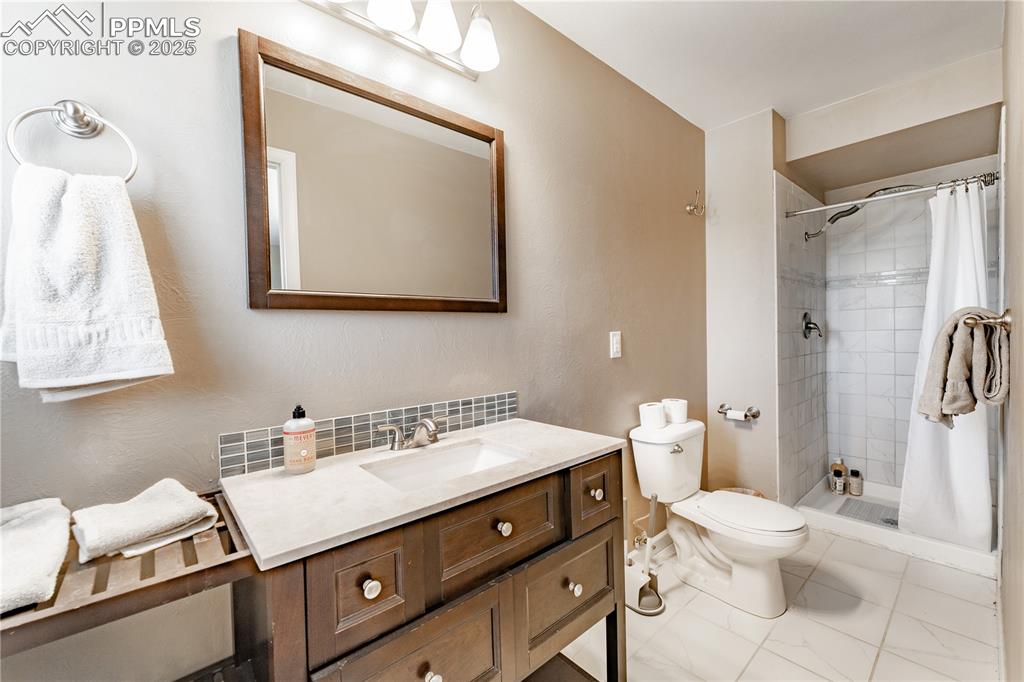 Full bath featuring vanity and a stall shower