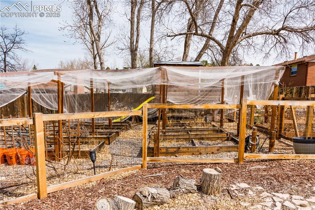 View of yard featuring a garden and an outdoor structure