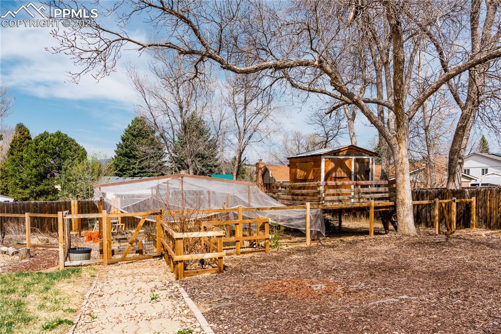 View of yard featuring an outbuilding, exterior structure, and a garden