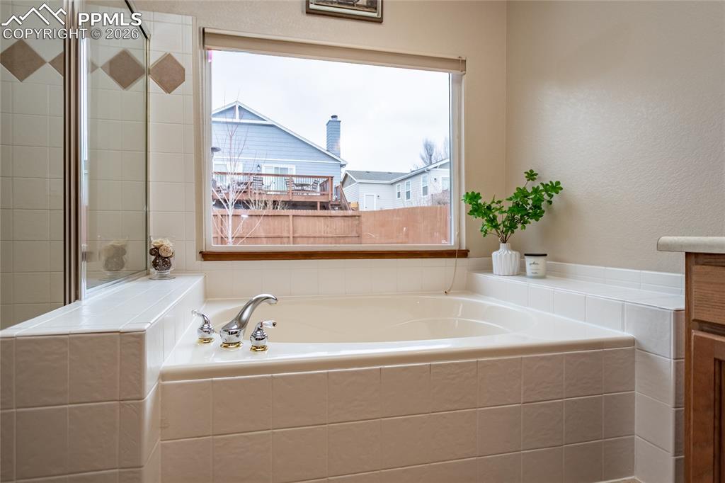 Beautiful soak-in tub with tile surround.
