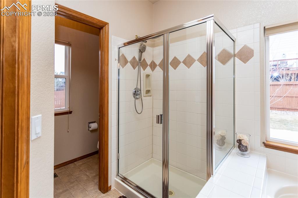Oversized shower with tile surround. Yes, there is a door separating the commode area for privacy! 