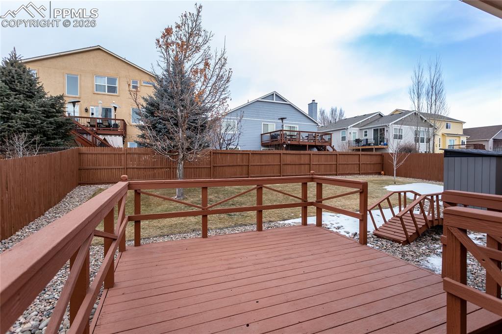 Beautiful deck helps you enjoy the well manicured back yard.