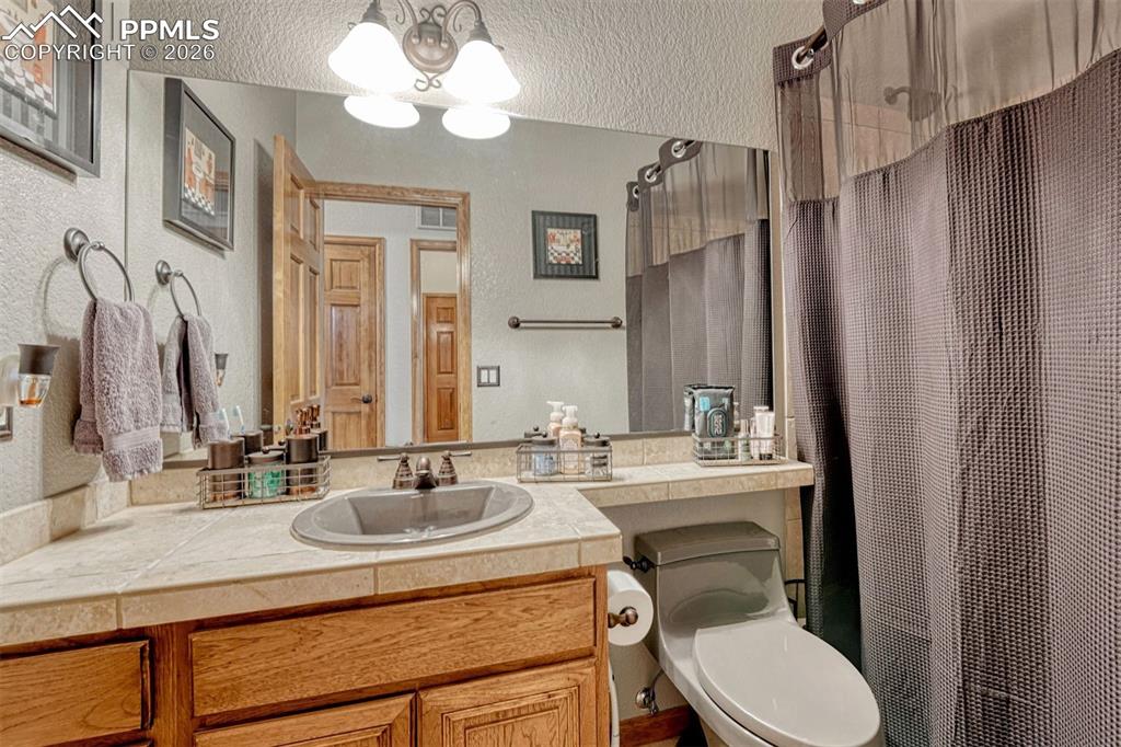 Main level guest bathroom. with vanity, a tub/shower combo.
