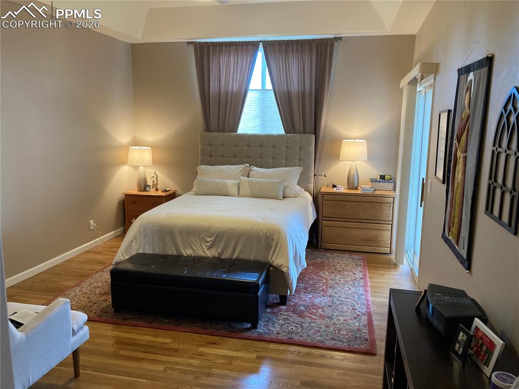 The large primary bedroom features a walk out to the deck, walk-in closet and adjoining primary bath.