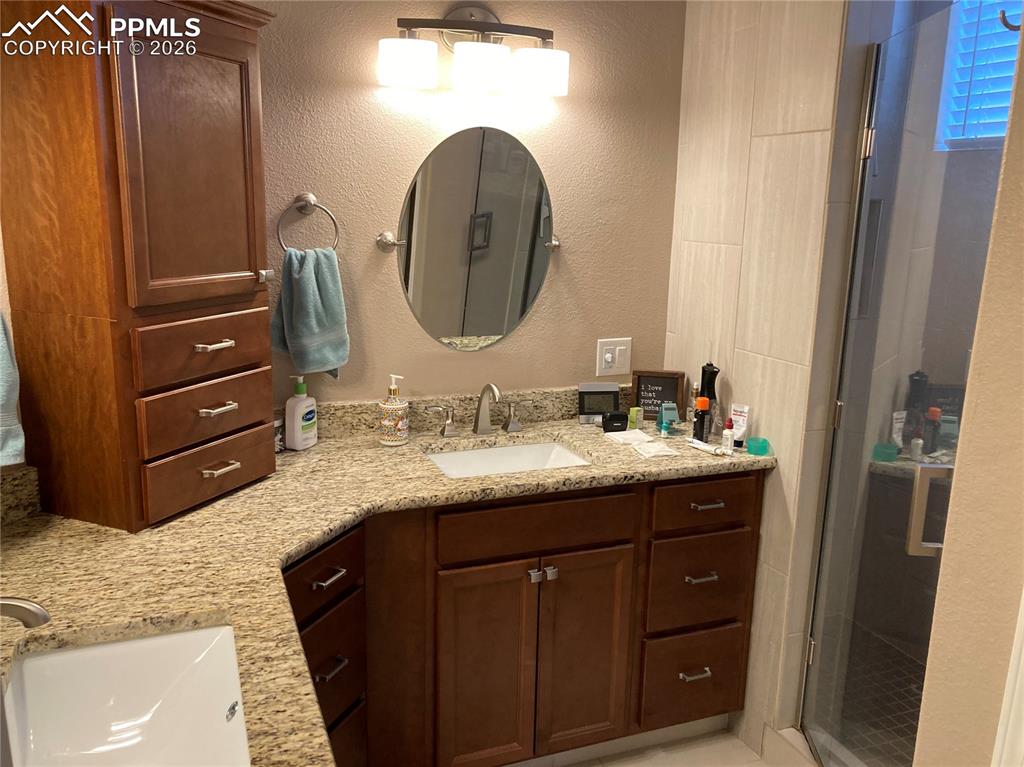 The primary bath has a beautiful walk in shower, double sinks, and a heated floor!