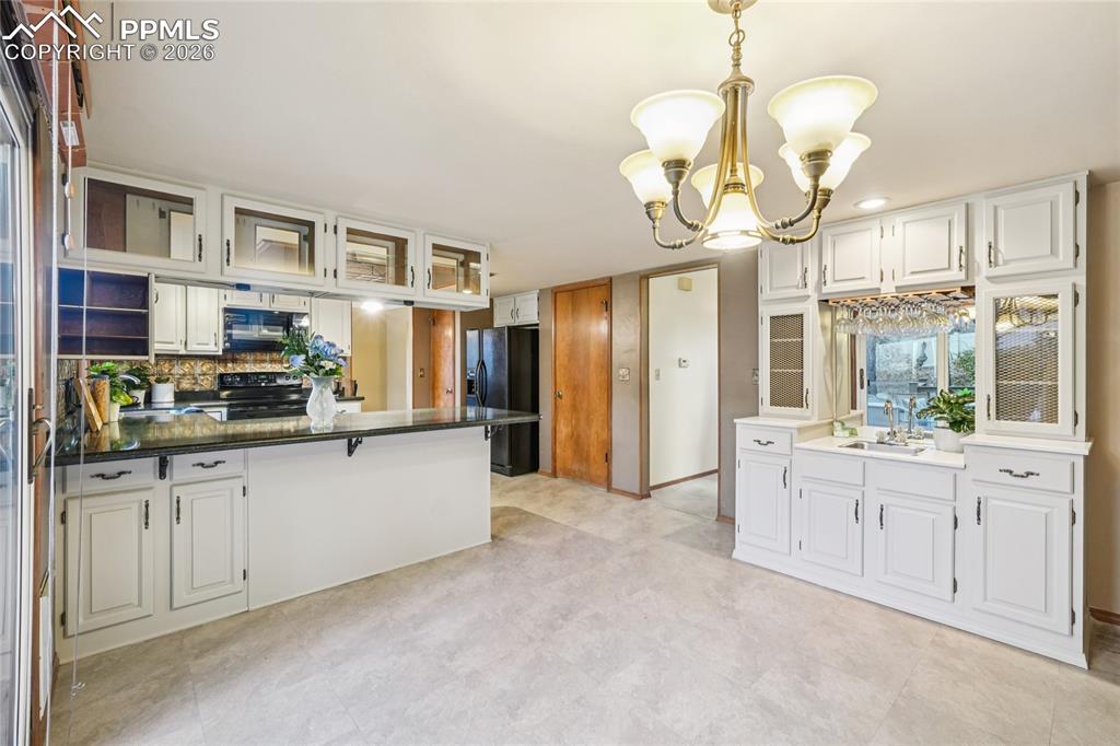 Kitchen extends to breakfast bar as well as entertainment area.