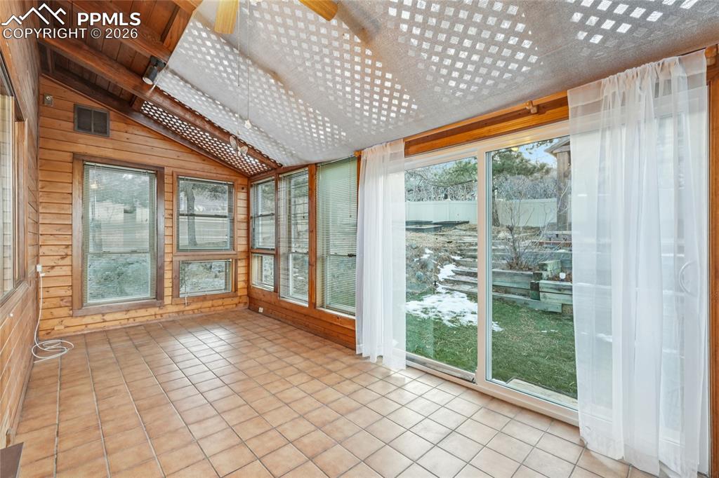 This sun room at rear of home exits to backyard or to deck.