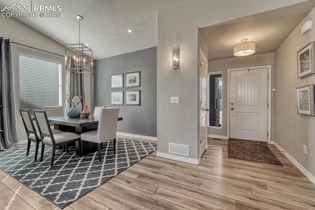 The Front Entry leads into the Formal Dining Room and has a coat closet and gorgeous luxury vinyl plank flooring.