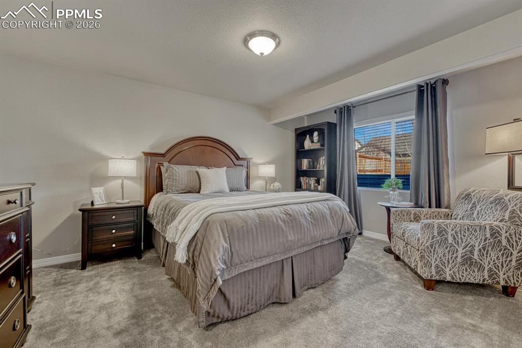 Basement Bedroom #3 with neutral carpet.