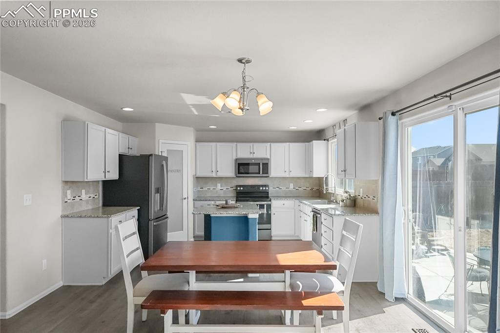 Kitchen with granite countertops and pantry.
