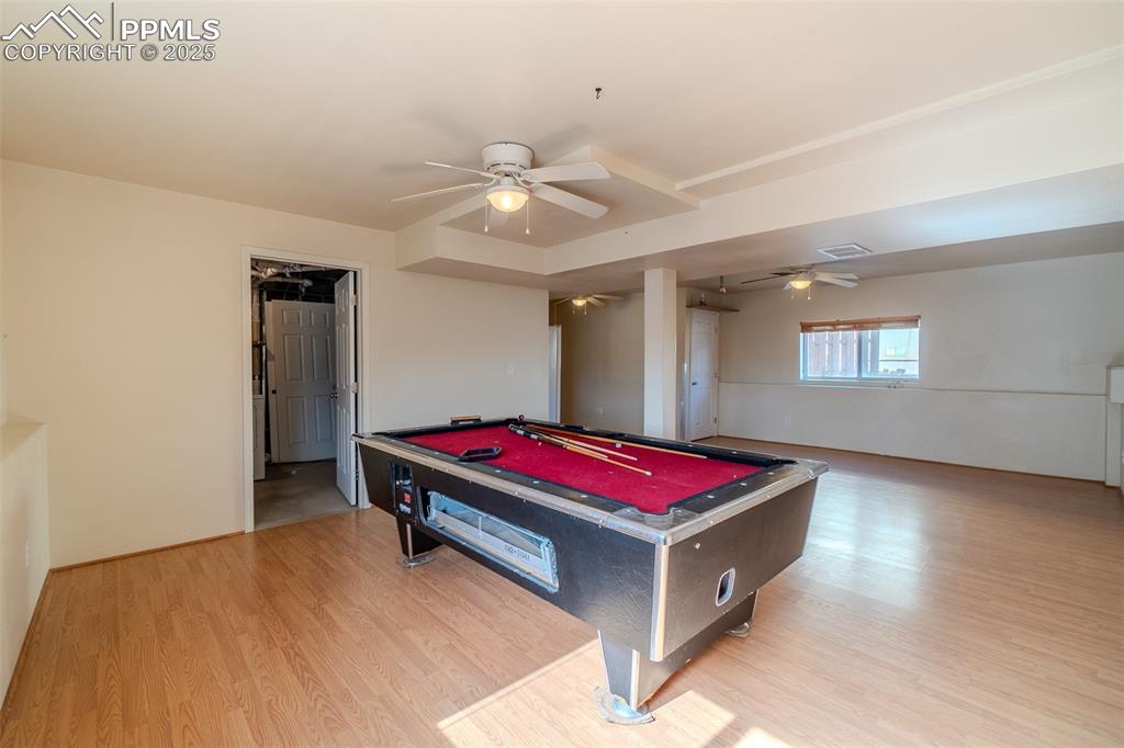 Rec room featuring billiards table, light wood-style floors, and a ceiling fan