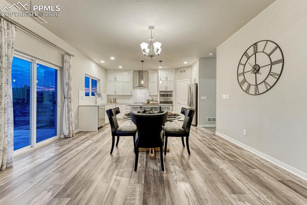Dining room with a chandelier and light wood-style flooring