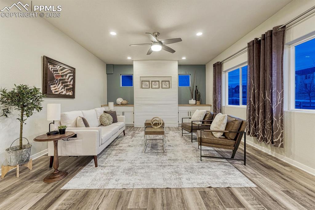 The living space includes a ceiling fan, light vinyl finished floors, and recessed lighting.