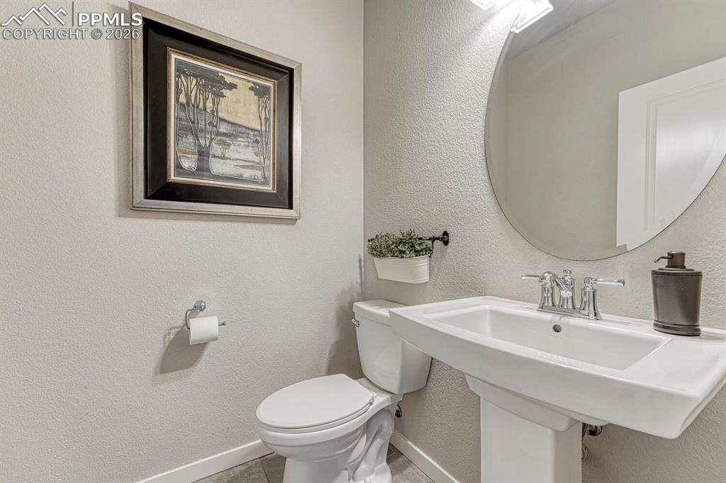 Bathroom with a textured wall and toilet