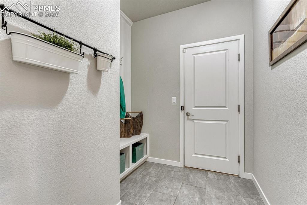 Create a seamless transition from outdoors to indoors with a stylish mudroom featuring shoe cubbies and coat hooks for a clutter-free life.