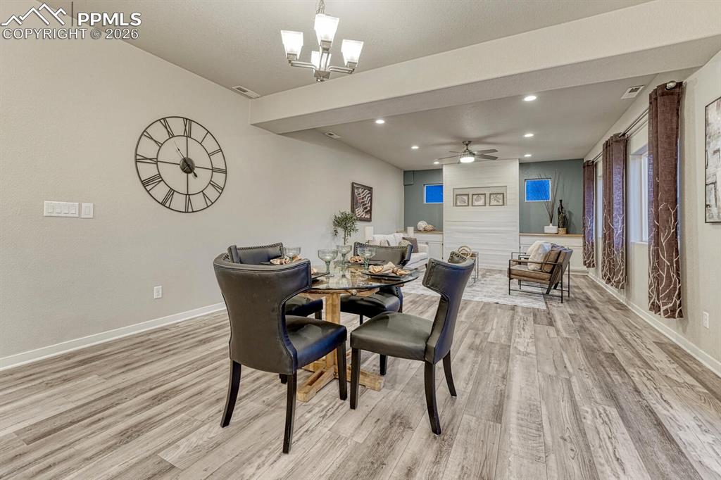 Dining space with ceiling fan, light wood-style floors, and recessed lighting