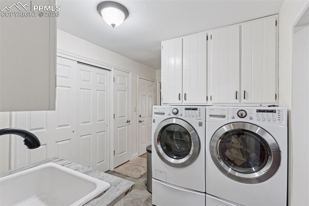 Laundry Room with storage space and farmhouse sink conveniently located off of garage