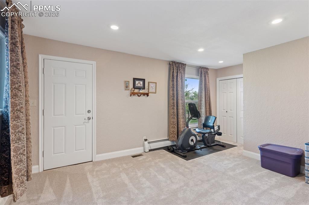 Potential second primary or bonus room with attached bath and access to exterior, ground level patio.