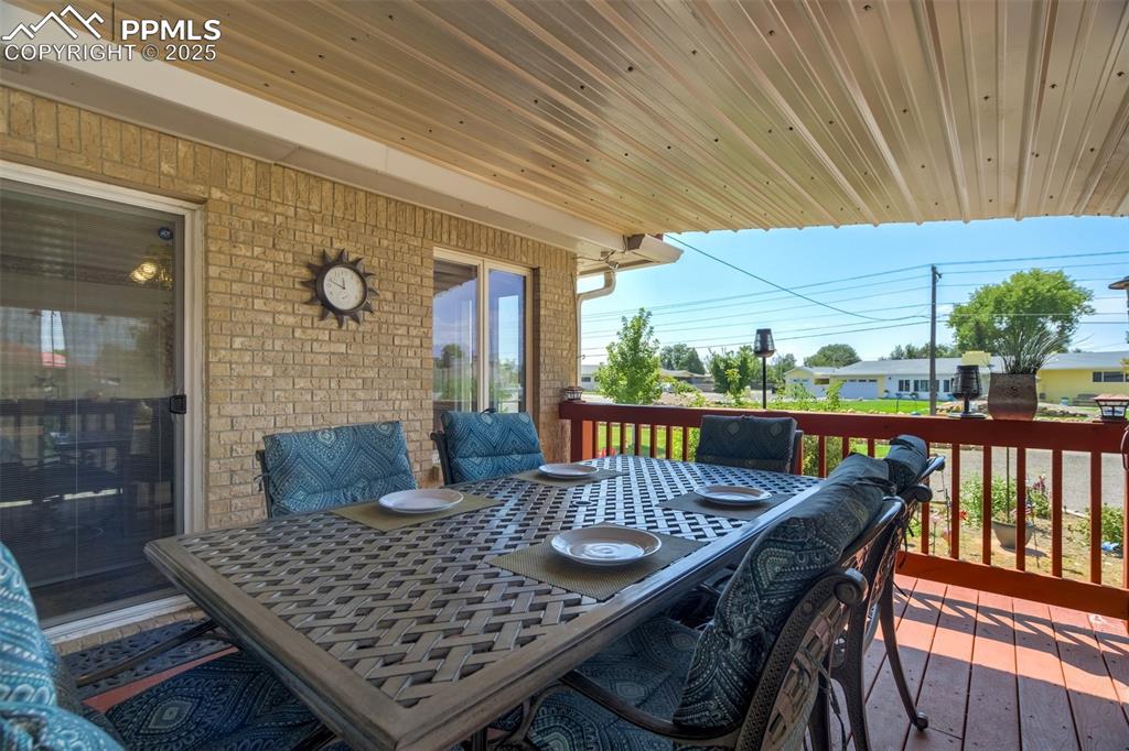 Wooden deck featuring outdoor dining area