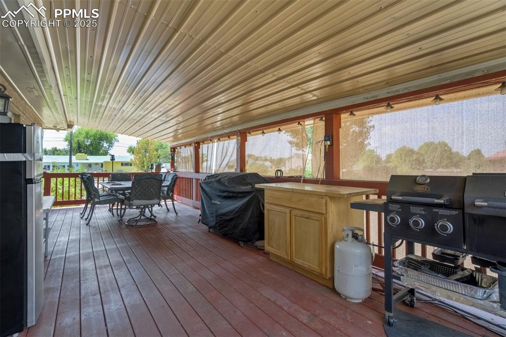 Wooden deck featuring outdoor dining area