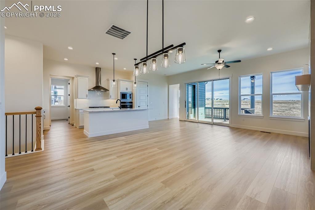 Unfurnished living room featuring recessed lighting, light wood finished floors, and ceiling fan