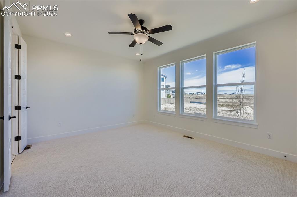 Empty room featuring light carpet, recessed lighting, and ceiling fan