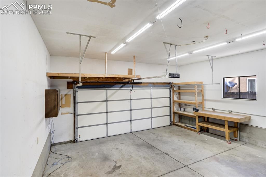 Over-sized 2 car garage finished with insulated garage door and garage door opener