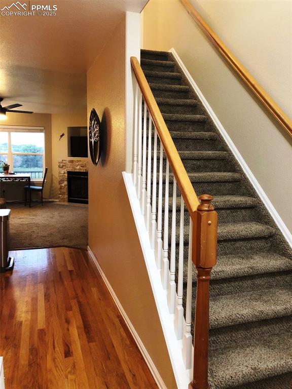 Stairway featuring wood floor