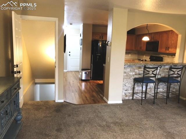 View to down stairs with arched  kitchen bar