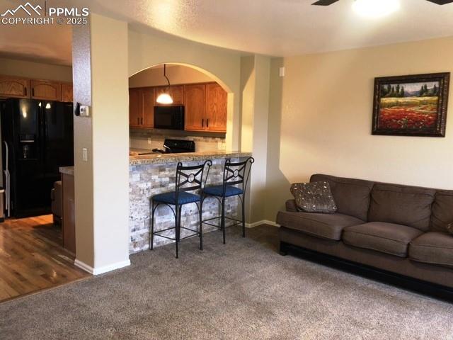 Living room with bar seating, stone accents