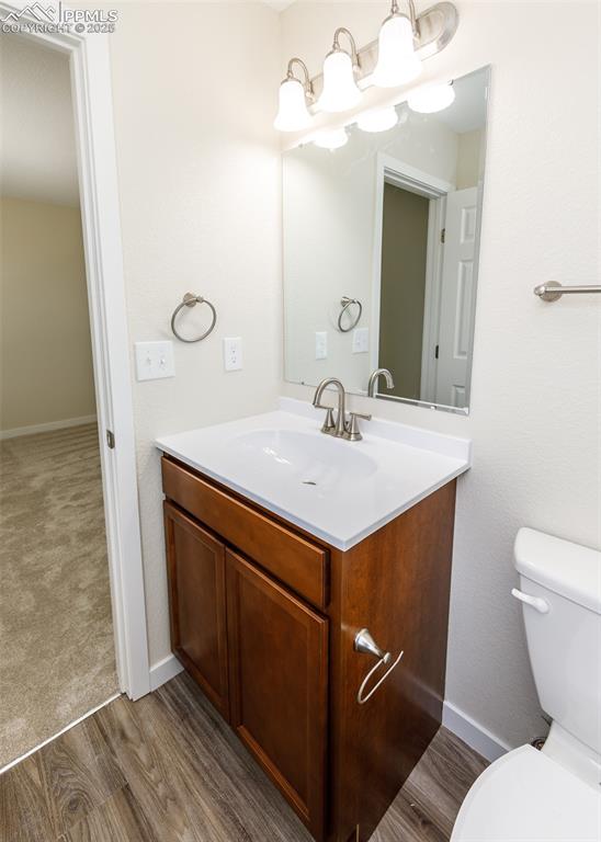 Bathroom featuring vanity and dark wood-style floors
