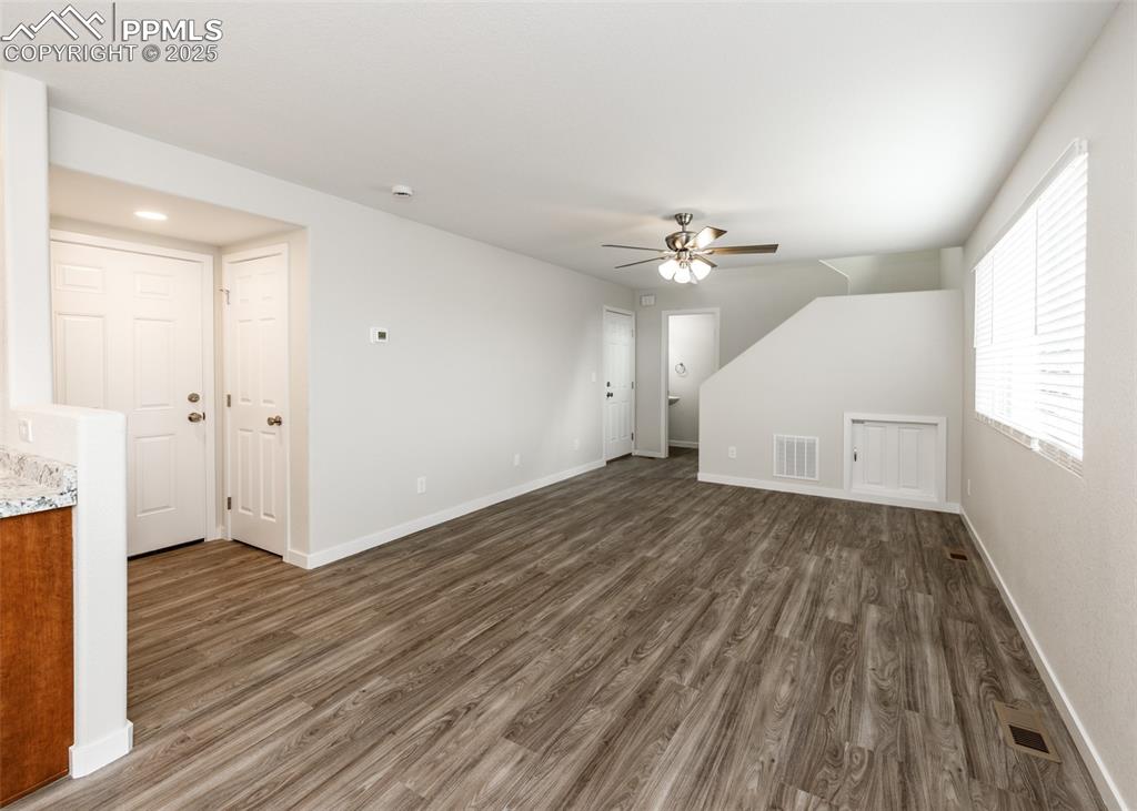 Bonus room featuring dark wood-style floors and ceiling fan